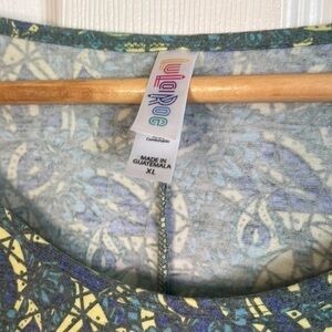 LulaRoe shirt. Peacock like print. Great colors.